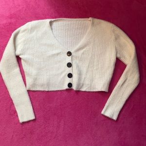 Very soft, cropped, with black buttons.